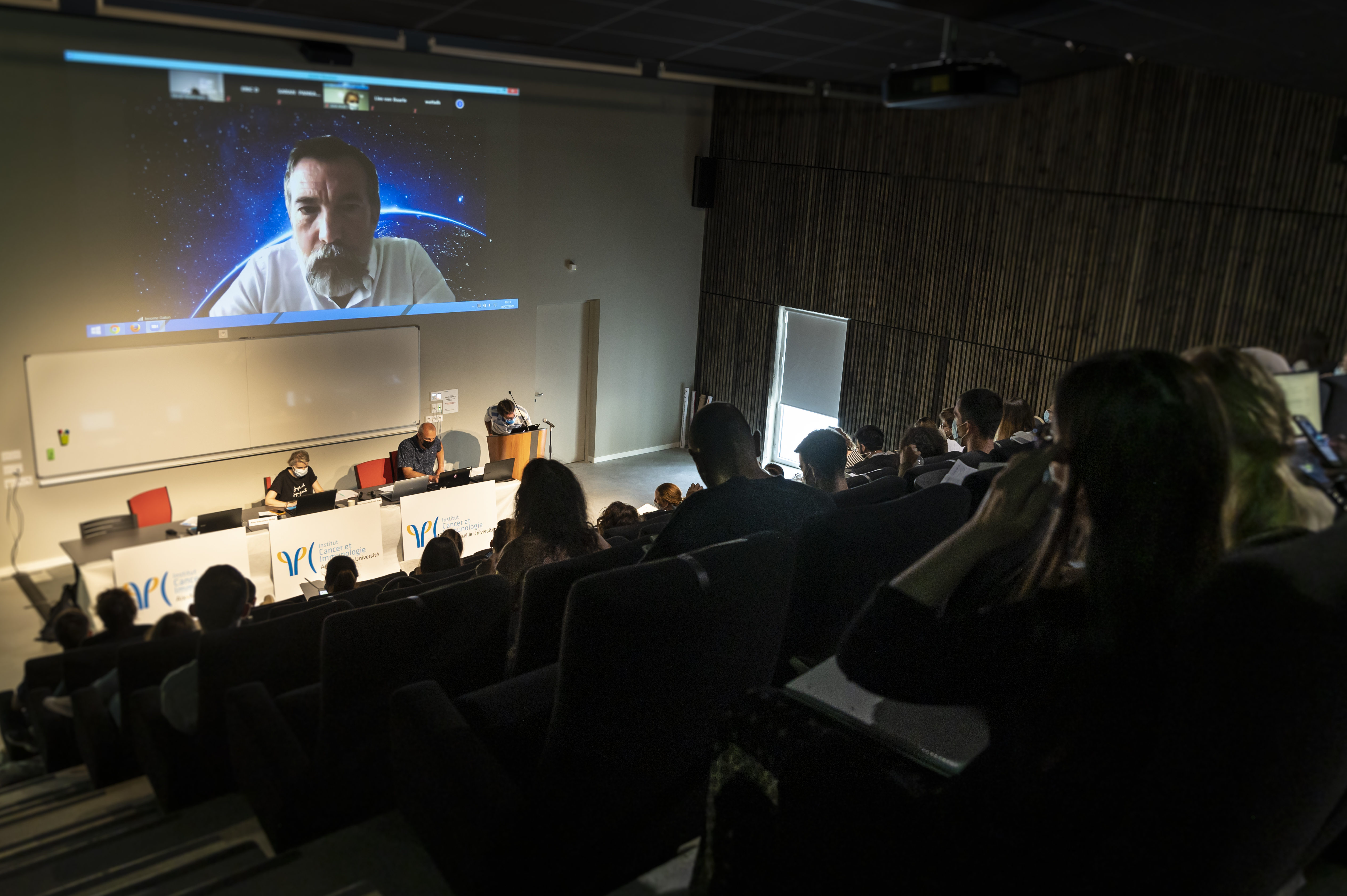 Students watch a remote lecture