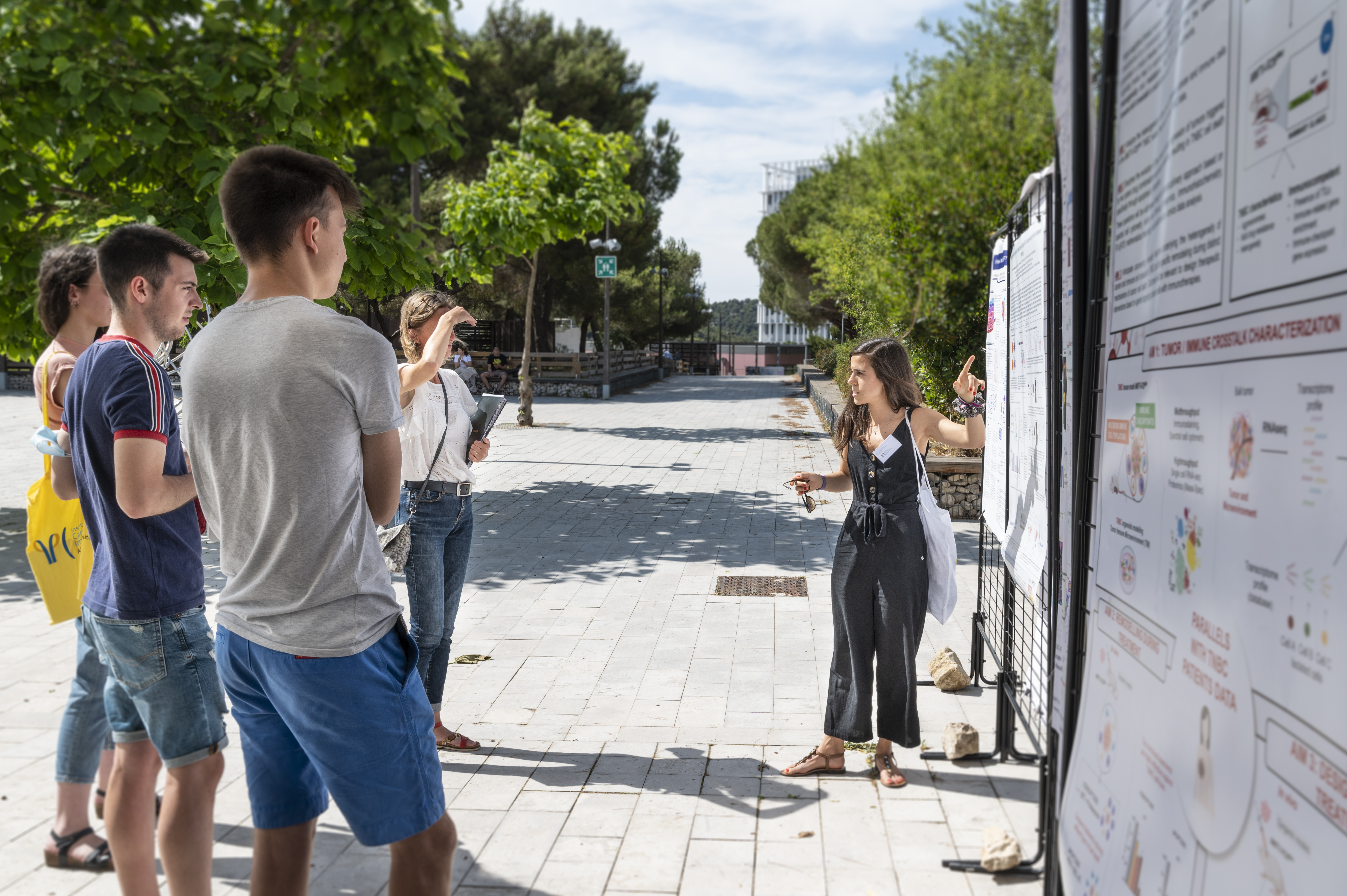 A student presents her research at the outdoor poster fair